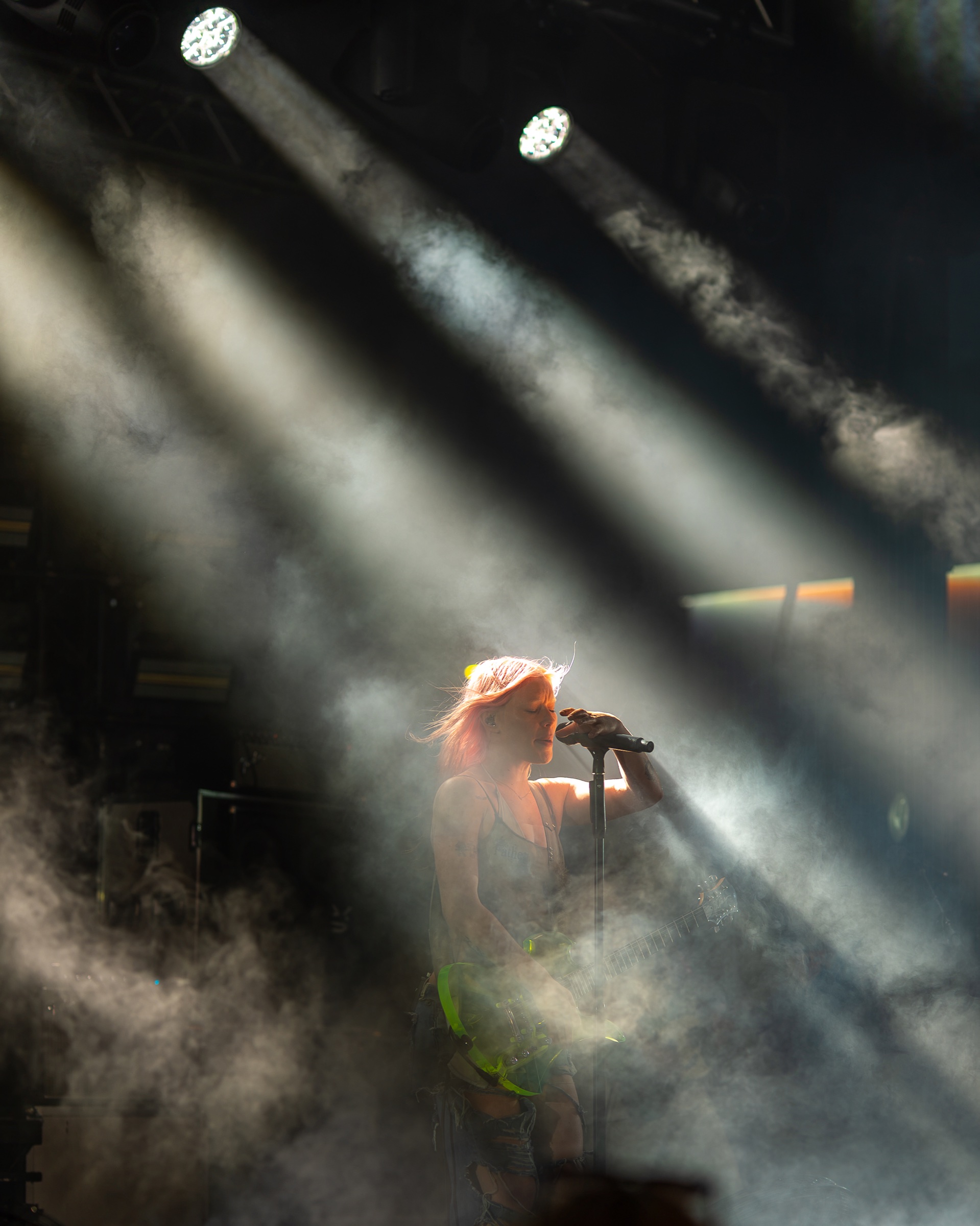 Rhian Teasdale caught in a narrow beam of light above the crowd