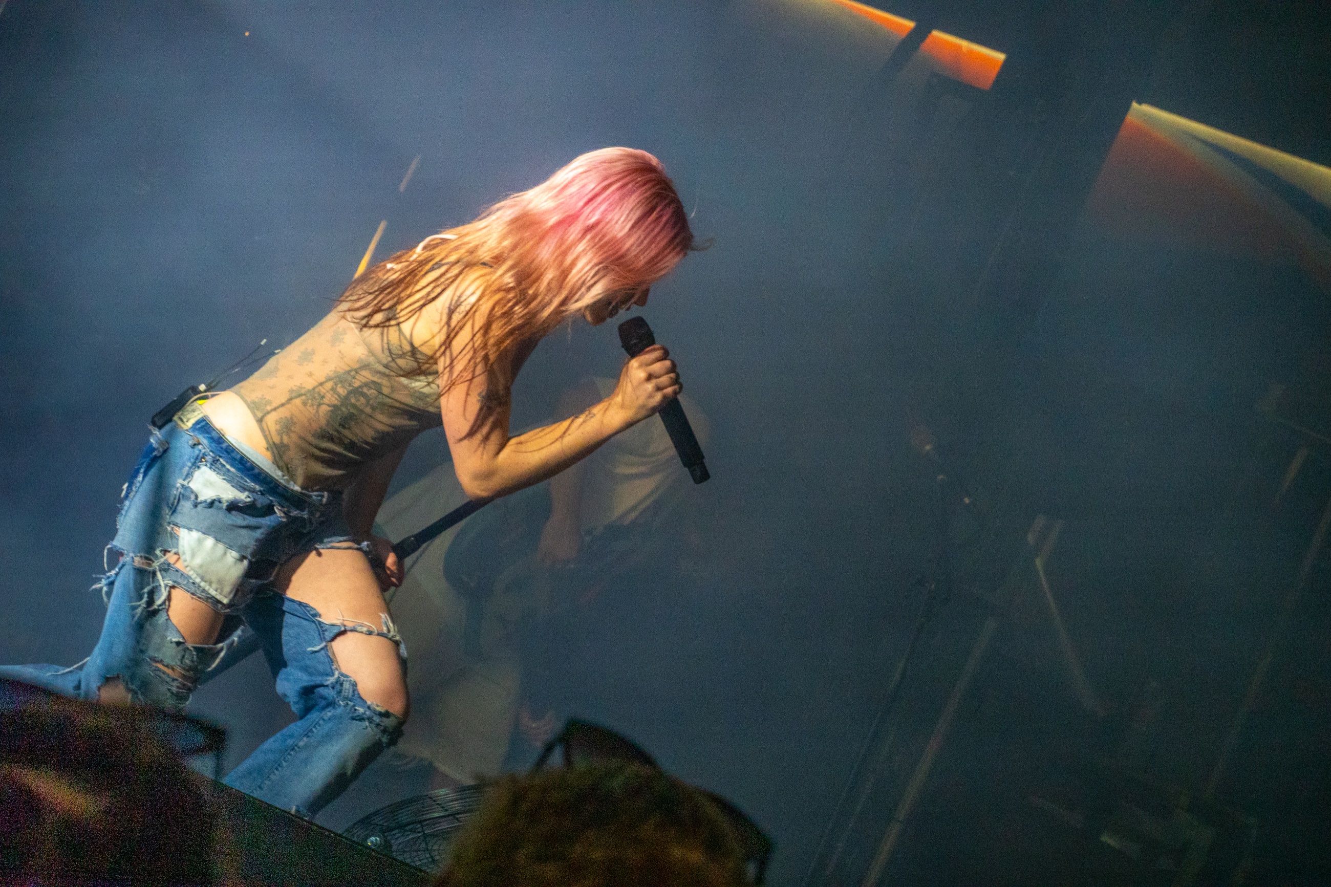 Rhian Teasdale lunging low with the microphone during Wet Leg's closing set